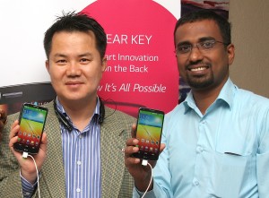 Mr. Josep Kim, the Managing Director of LG East and Central Africa (left) and Mr. Leney Varghese, the Manager Sales and Marketing, Mobile Division of LG East Africa (right) display the newly launched LG G2 smartphone which is billed to topple its android rivals in the market. The phone will be available in Kenyan shops from the last month of October 2013.  