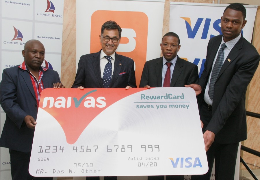 Naivas Supermarkets Chairman Mr Simon Mukuha (left), Chase Bank Group Managing Director Mr Zafrullah Khan, Chase Bank Deputy CEO Mr Paul Nyaga, (middle) and Visa Country Manager of Subsaharan Africa Jabu Basopo (right); hold the Chase Bank-Naivas-Visa dummy cheque during the unveil of the prepaid card.
