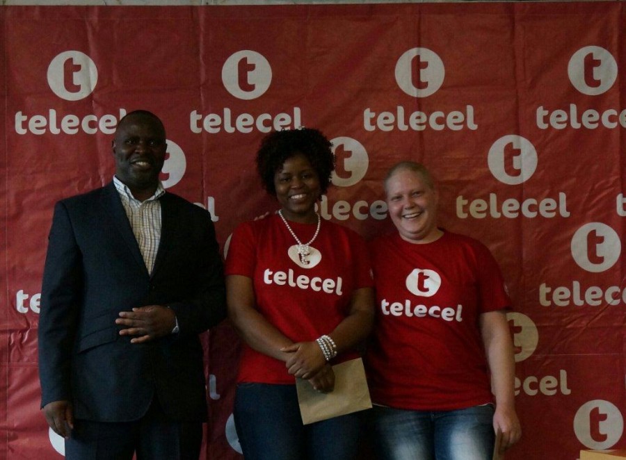 Mr Godzi pictured with Faith Musevenzi and Chianne Godwin, both from Telecel’s Sales Department, after handing to them the proceeds of Telecel’s fund raising activities.  