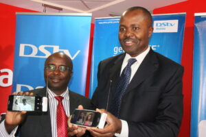 Airtel Kenya head of Corporate Communications and Brand Dick Omondi and DStv Mobile General Manager Felix Kyengo display the DStv Drifta during the partnership launch