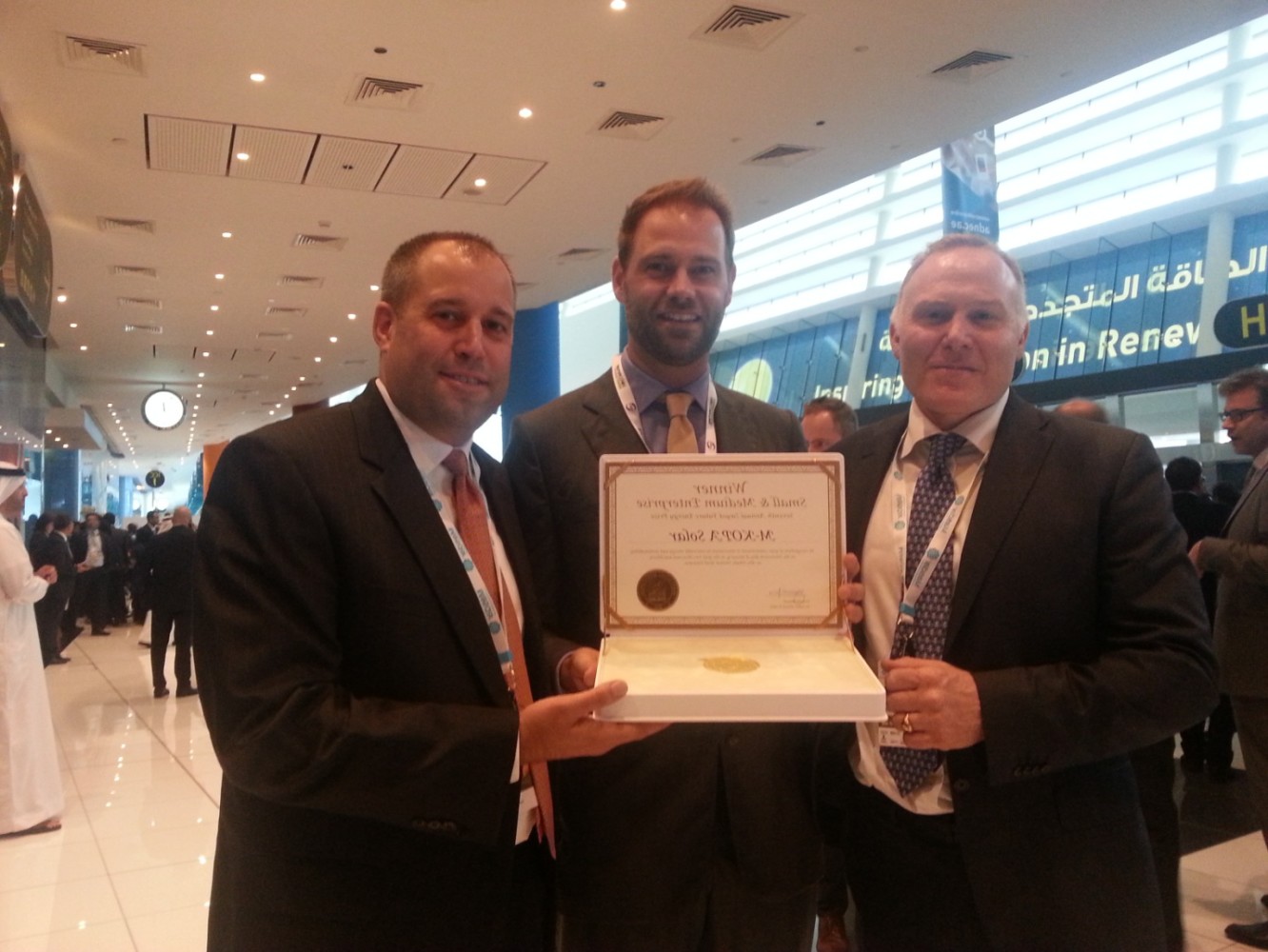 From Left to right: M-KOPA Solar Executive Chairman Nick Hughes with Jesse Moore Managing Director, and Chad Larson, Finance Director display the award certificate after winning in the SME Category of Zayed Future Energy Prize 2015. 